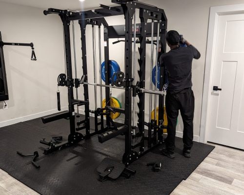 Modern home gym with weightlifting station and accessories.